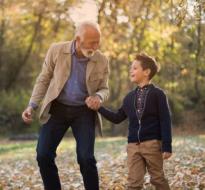AcornsOakTrees_Logo.jpg A man and kid walking together holding hands