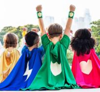 SuperCoders_Logo.jpg Kids with capes raising their hands over their heads facing away from the camera
