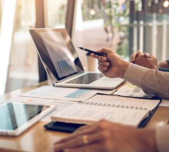 people looking at a report on a laptop