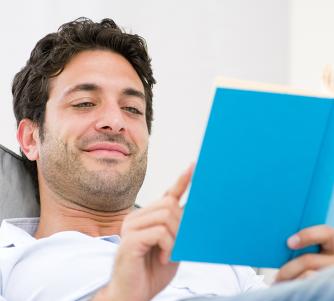 Man reading a blue book