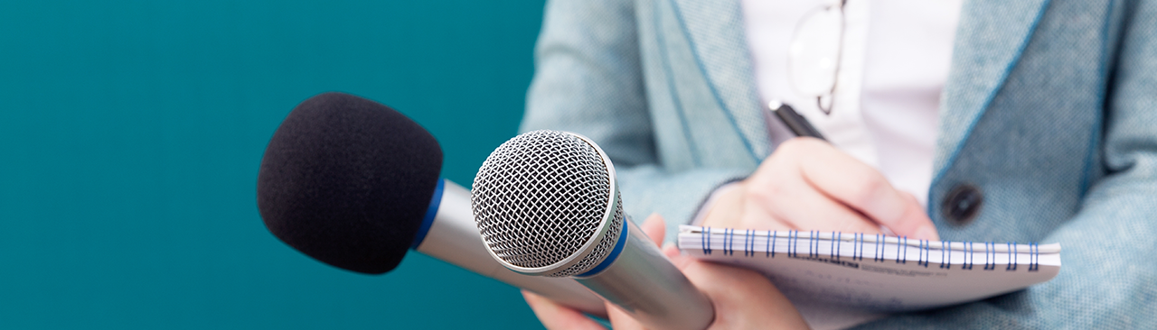 Lady with microphone and taking notes