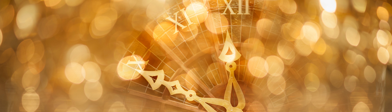 shimmery gold lights and the face of a clock about to strike midnight