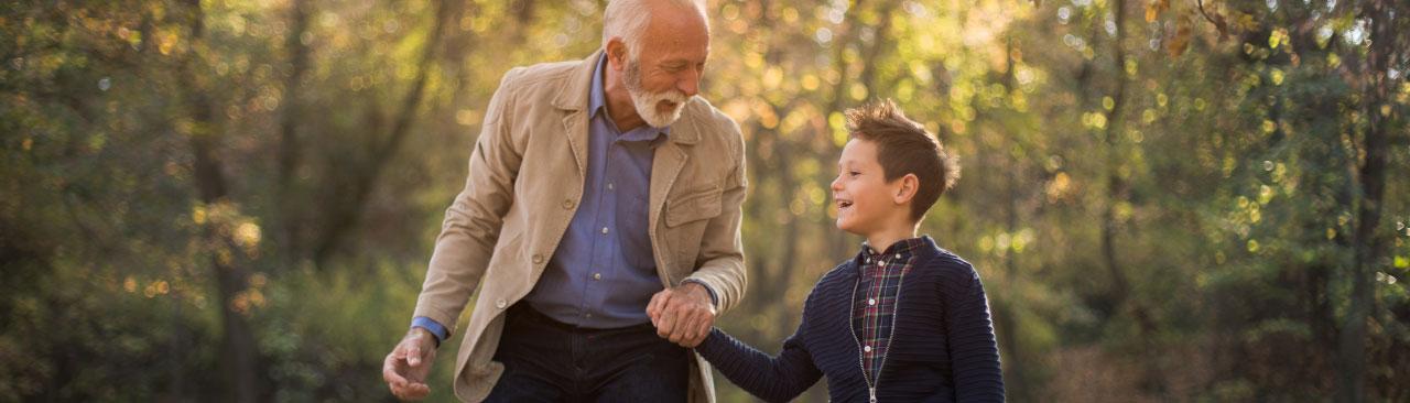 AcornsOakTrees_hero.jpg A senior and a child conversing amongst some trees