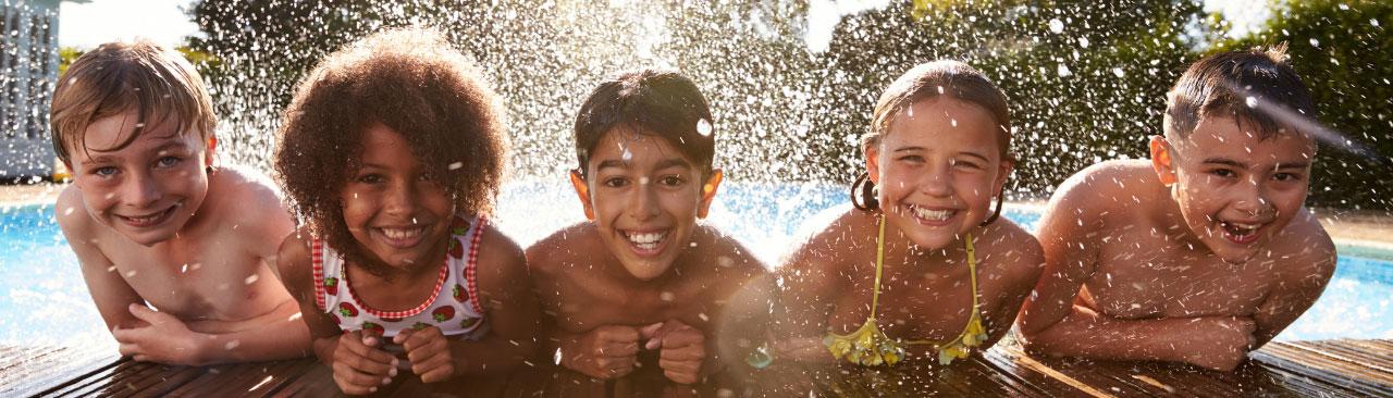Beat-the-Heat_hero.jpg Five kids on the deck of a swimming pool