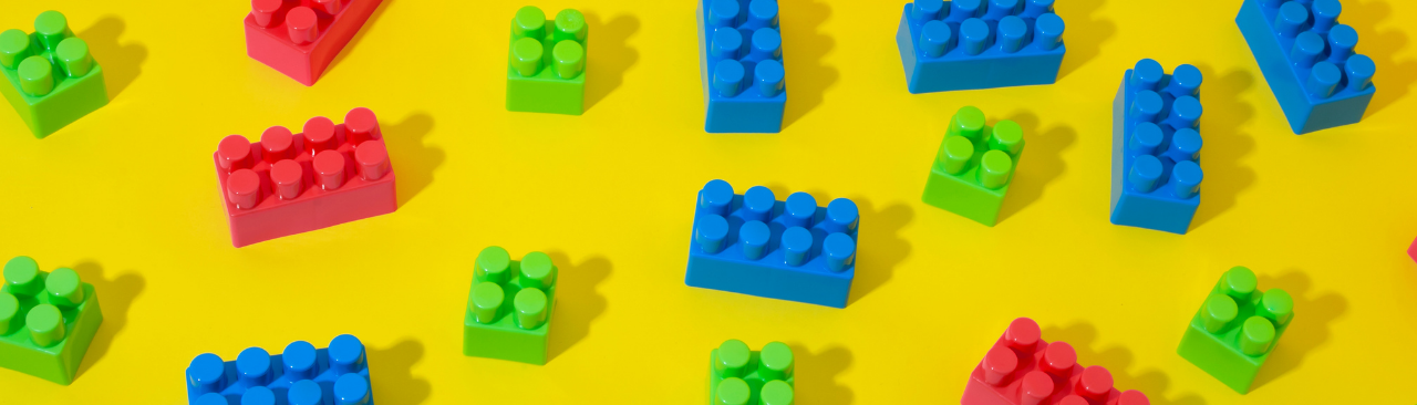 lego_hero.png lego pieces on a yellow background