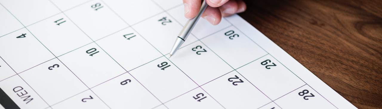 Pen pointing to a calendar day