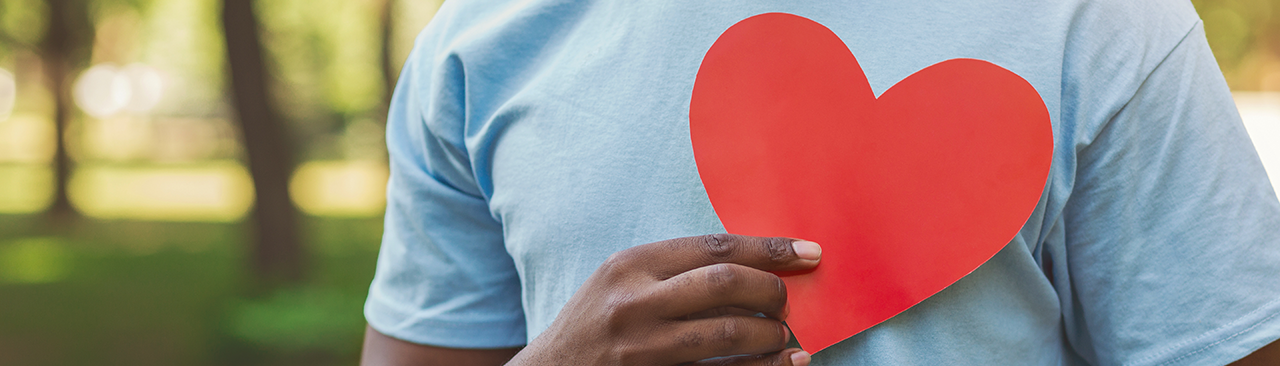 man with blue shirt and red heart